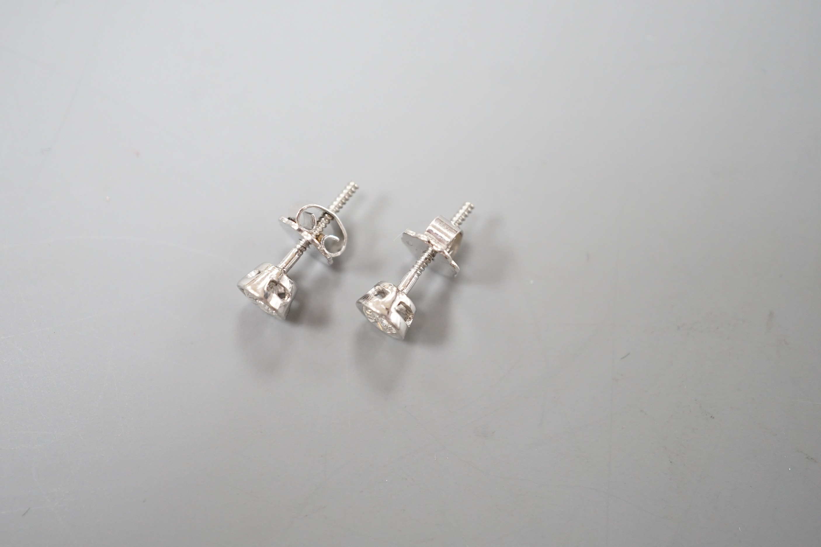 A pair of 750 white metal and collet set solitaire diamond ear studs, gross weight 1.5 grams, stone diameter approx. 3.7mm.